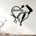 Black hairstylist wall sign displayed on a light wood-paneled wall in a salon-inspired interior