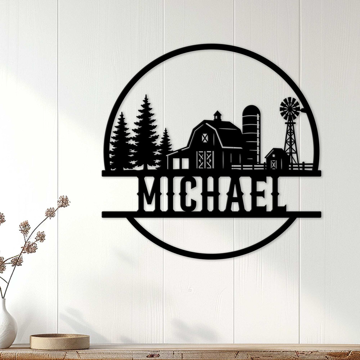 Black farm wall decor displayed on a white paneled wall above a wooden console