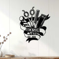 Hairstylist metal wall sign displayed on a light wood-paneled wall in a modern home setting
