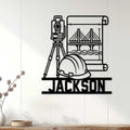 Civil engineer wall decor displayed on a light wood wall with a surveyor tool, hard hat, bridge, and blueprints