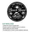 Beach house metal sign feature graphic showing a round coastal design with dolphins, palms, waves, and a sun
