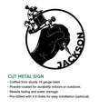 Cut metal sign artwork showing a tattooed hand using a tattoo machine in a bold circular emblem