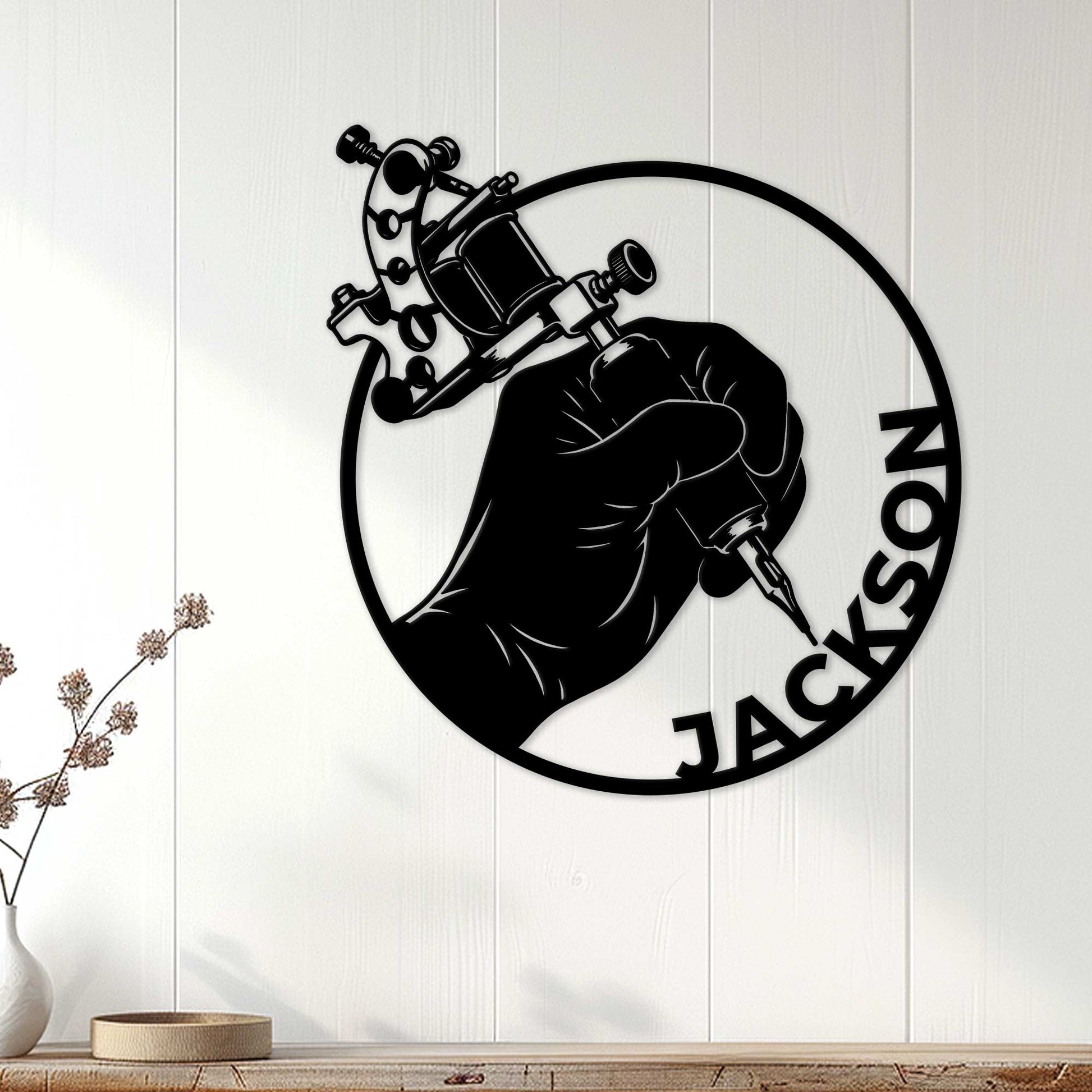 Tattoo artist metal wall sign displayed on a white paneled wall in a modern interior