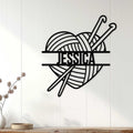 Knitting-themed metal wall sign displayed on white paneling above a console for craft room decor