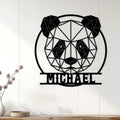 Geometric panda wall sign displayed on a light paneled wall above a simple console