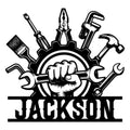 Mechanic metal sign featuring a raised fist, gear, wrench, hammer, pliers, screwdriver, and bold garage-style design