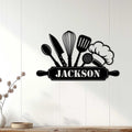 Custom kitchen metal sign with chef hat and cooking utensils displayed on a white paneled wall