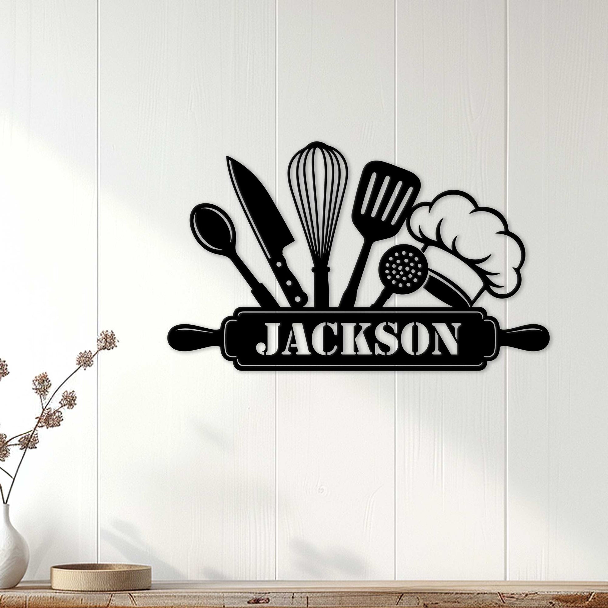Custom kitchen metal sign with chef hat and cooking utensils displayed on a white paneled wall