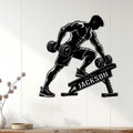 Black bodybuilder weightlifting metal sign displayed on a light wood-paneled wall in a modern room