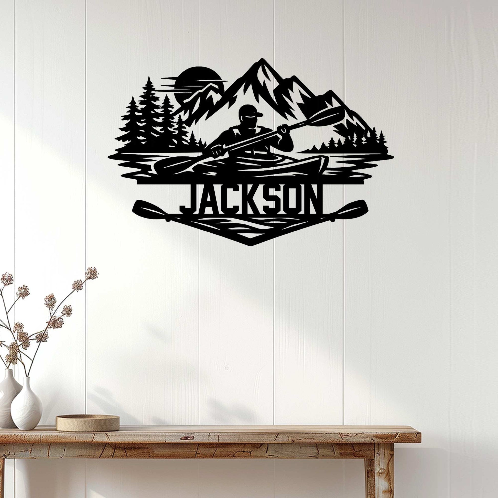 Kayaking metal wall decor displayed on a light wood wall above a console table