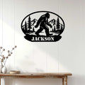 Black Bigfoot silhouette metal wall sign displayed on a light wood-paneled wall