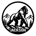 Gorilla metal sign featuring a bold black wildlife silhouette framed by mountains and evergreen trees