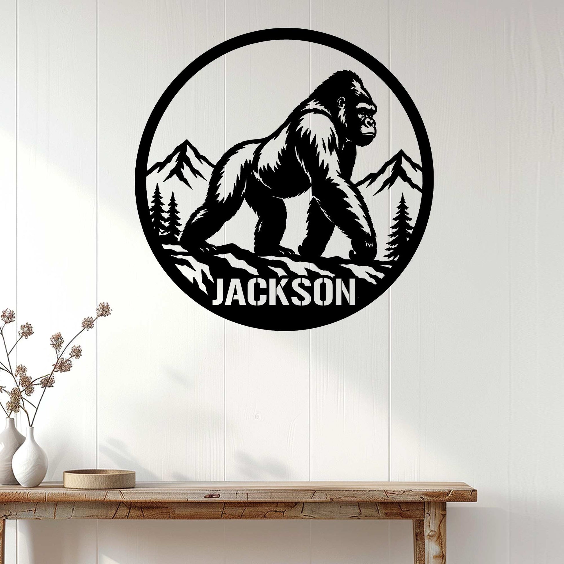 Gorilla wall decor displayed on a white paneled wall above a rustic console table