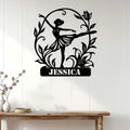 Ballerina metal wall sign displayed on a light wood-paneled wall above a console table