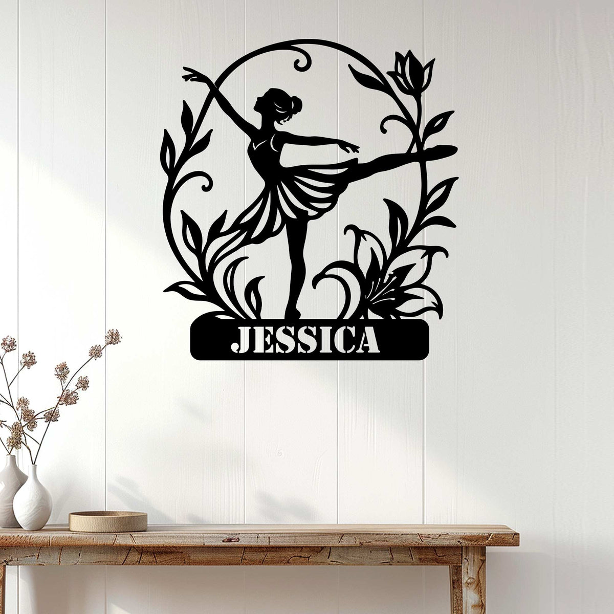 Ballerina metal wall sign displayed on a light wood-paneled wall above a console table