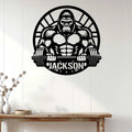 Gorilla barbell metal wall sign displayed on a bright paneled wall above a console