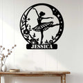 Ballet dancer metal wall sign displayed on a light paneled wall above a console table