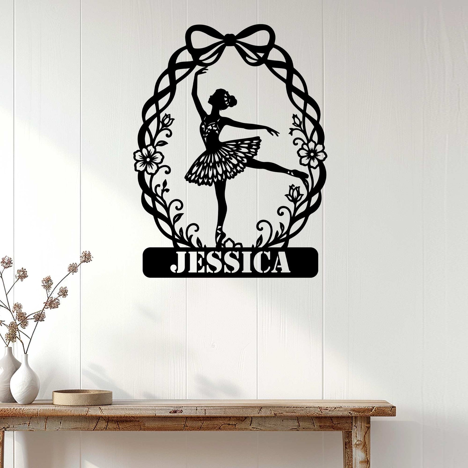 Ballet dancer metal wall sign displayed on a bright white paneled wall