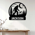 Bigfoot metal wall sign displayed on a white wood-paneled wall above a rustic console table