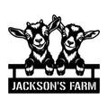 Black metal goat farm sign featuring two cheerful goats leaning over a fence with a broad custom sign panel