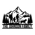 Custom trekking metal sign with a family hiking silhouette, mountain peaks, pine trees, winding trail, and dog