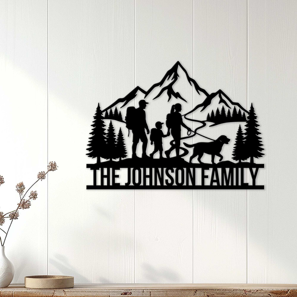 Trekking family metal sign displayed on a white paneled wall as outdoor-inspired home decor
