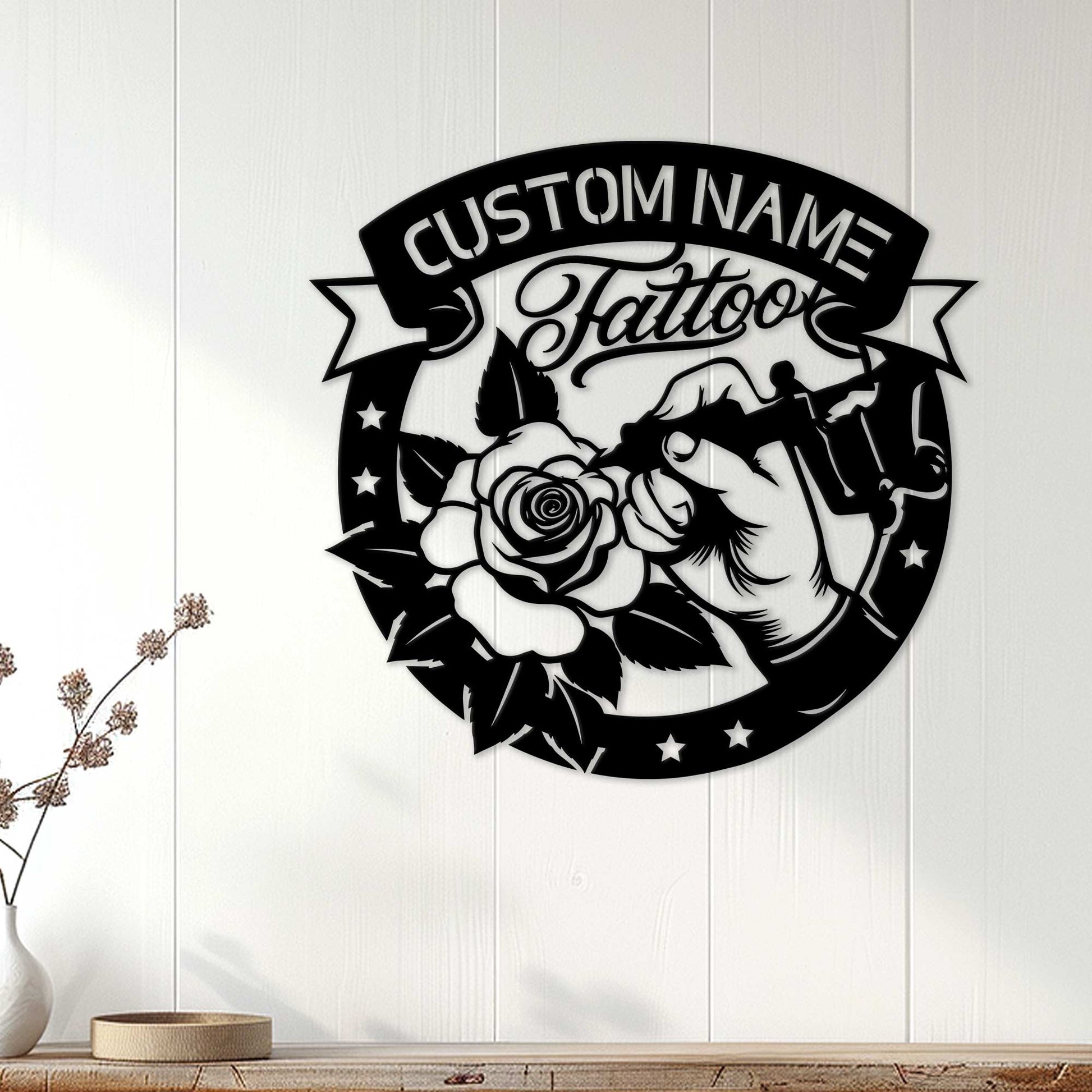 Tattoo studio wall decor displayed on a white paneled wall with a rose and tattoo machine design