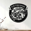 Tattoo artist metal wall sign displayed on a white paneled wall above a wood console