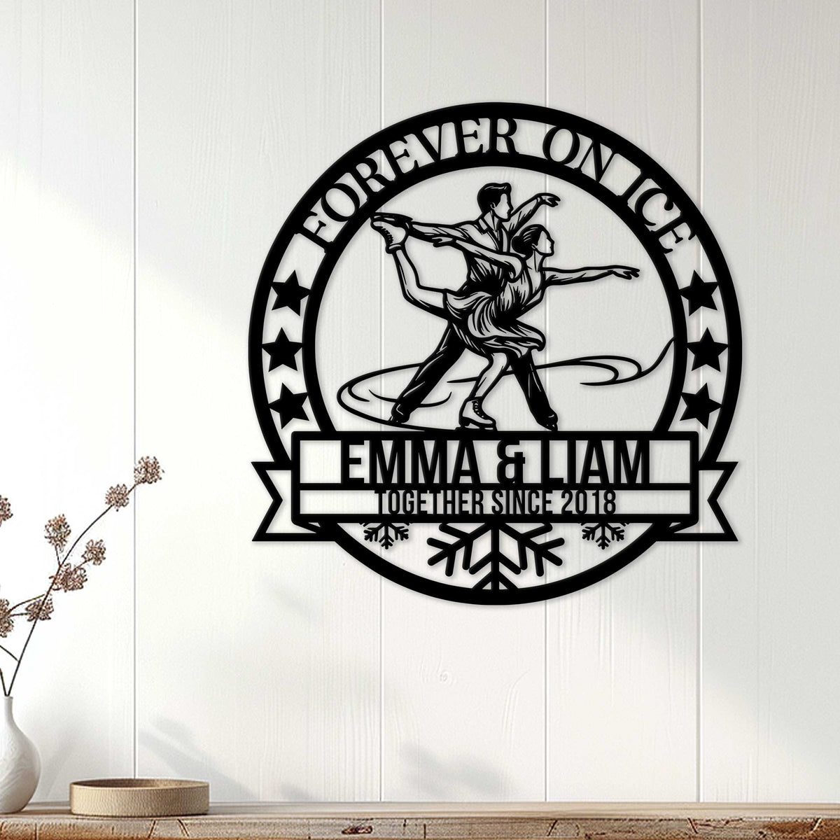 Ice skating couple wall sign displayed on white paneled home decor