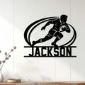 Rugby player wall decor displayed as a bold black silhouette sign on a light wood-paneled wall