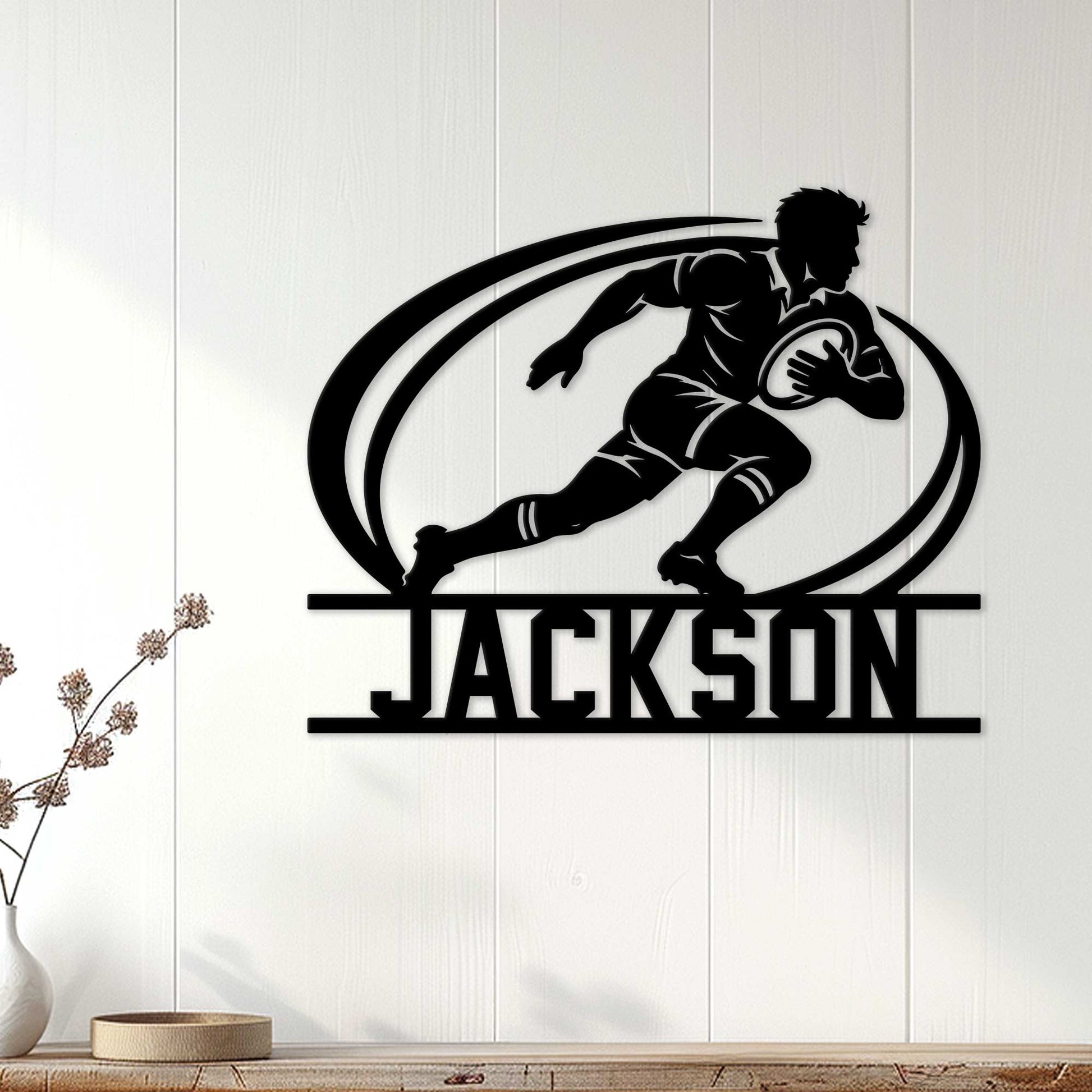 Rugby player wall decor displayed as a bold black silhouette sign on a light wood-paneled wall