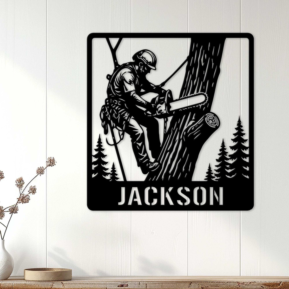 Arborist wall decor displayed on a light wood wall, featuring a climber cutting a large tree