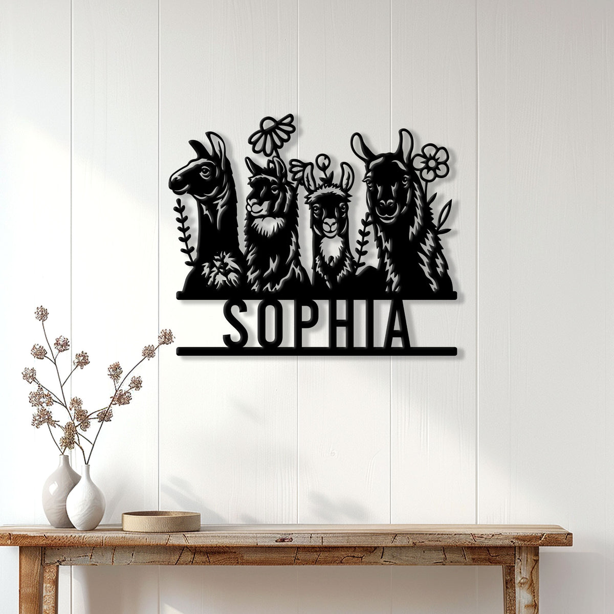 Alpaca family wall sign displayed on a light paneled wall above a wooden console table