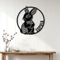 Ornate bunny metal wall sign displayed above a console table in a bright home interior