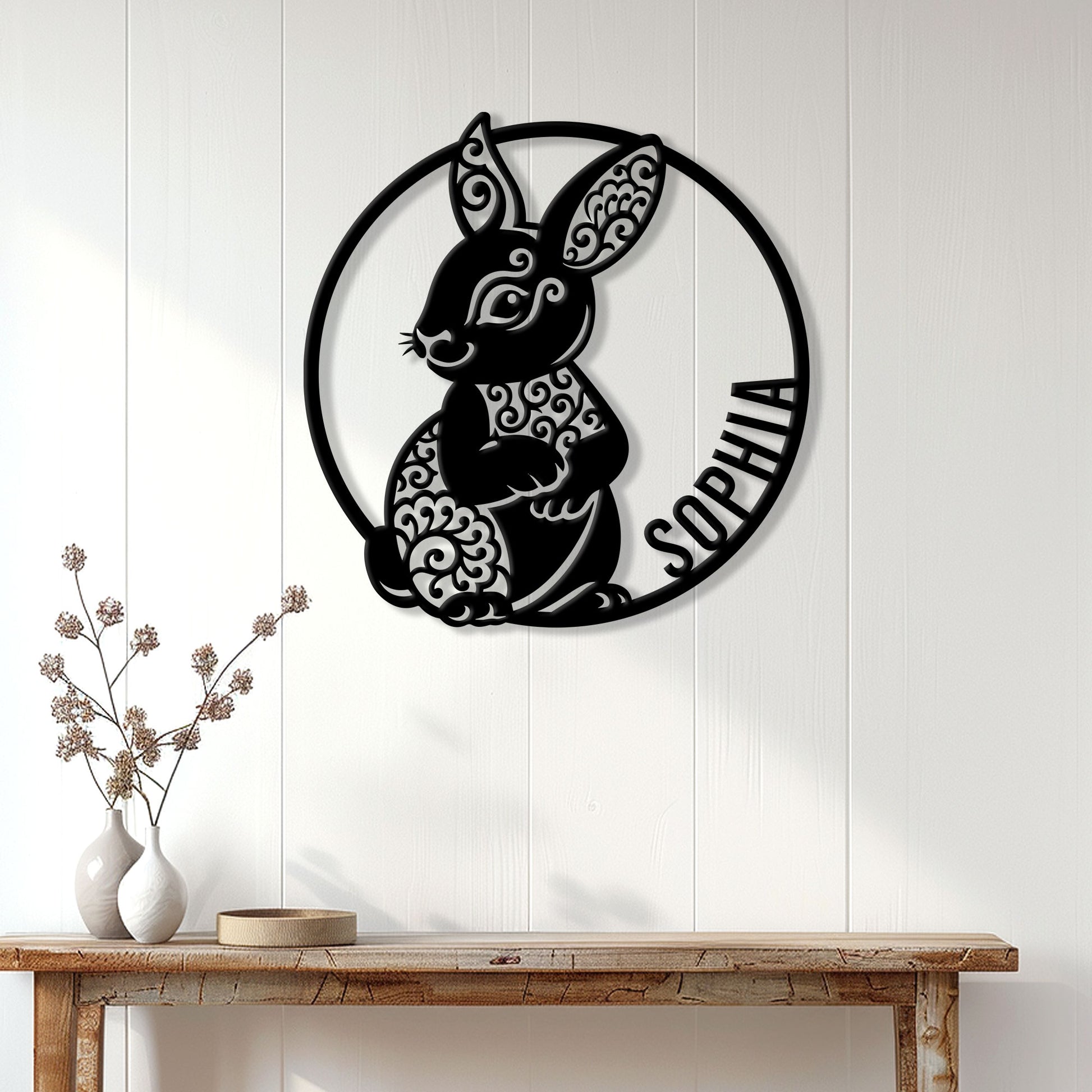 Ornate bunny metal wall sign displayed above a console table in a bright home interior