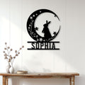 Black floral bunny metal sign displayed on a white paneled wall above a console table