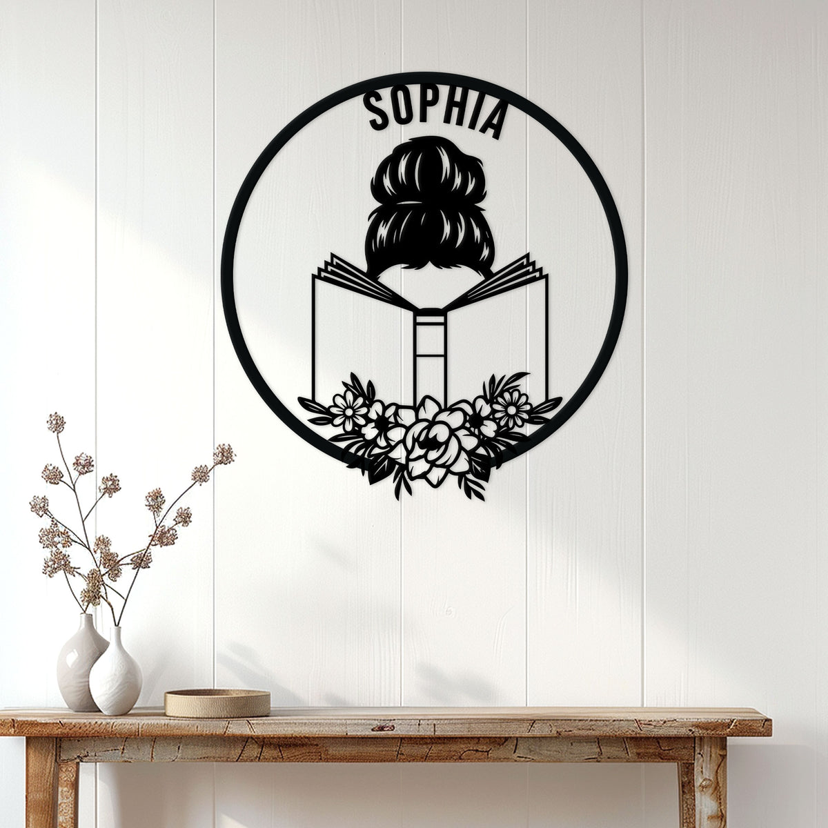 Black book reader metal wall sign displayed on a bright paneled wall above a console table