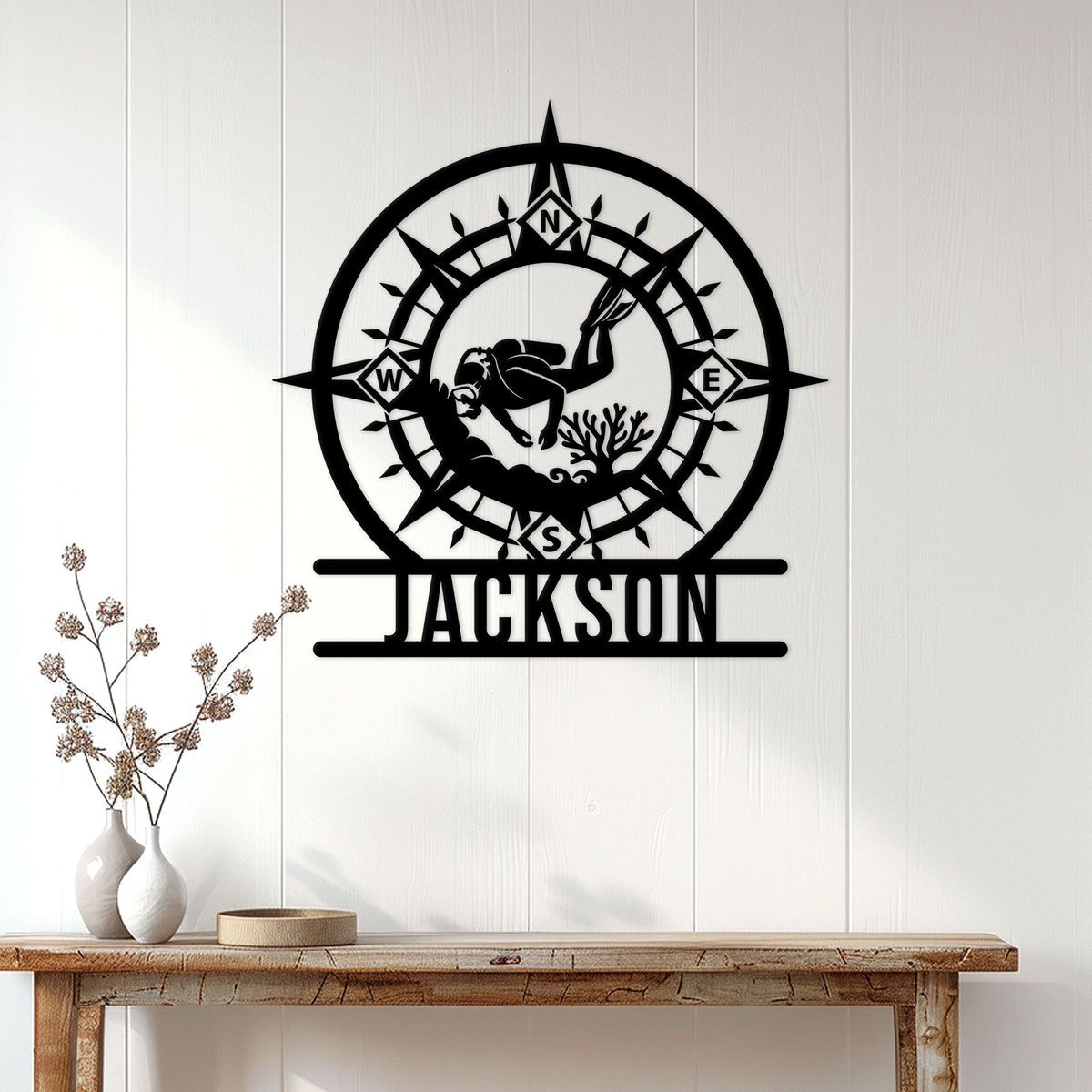 Scuba diving wall sign displayed on a white paneled wall above a console table