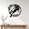 Scuba diver metal wall sign displayed on a light wood-paneled wall in a bright home