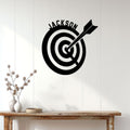 Custom archery target sign displayed on a light wood-paneled wall in a home decor setting