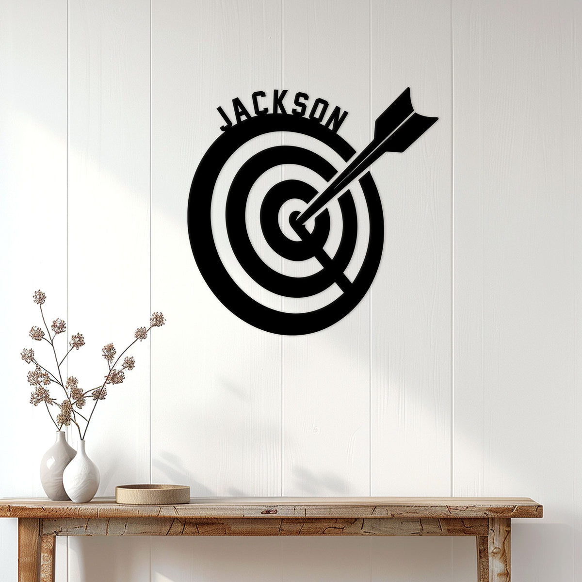 Custom archery target sign displayed on a light wood-paneled wall in a home decor setting
