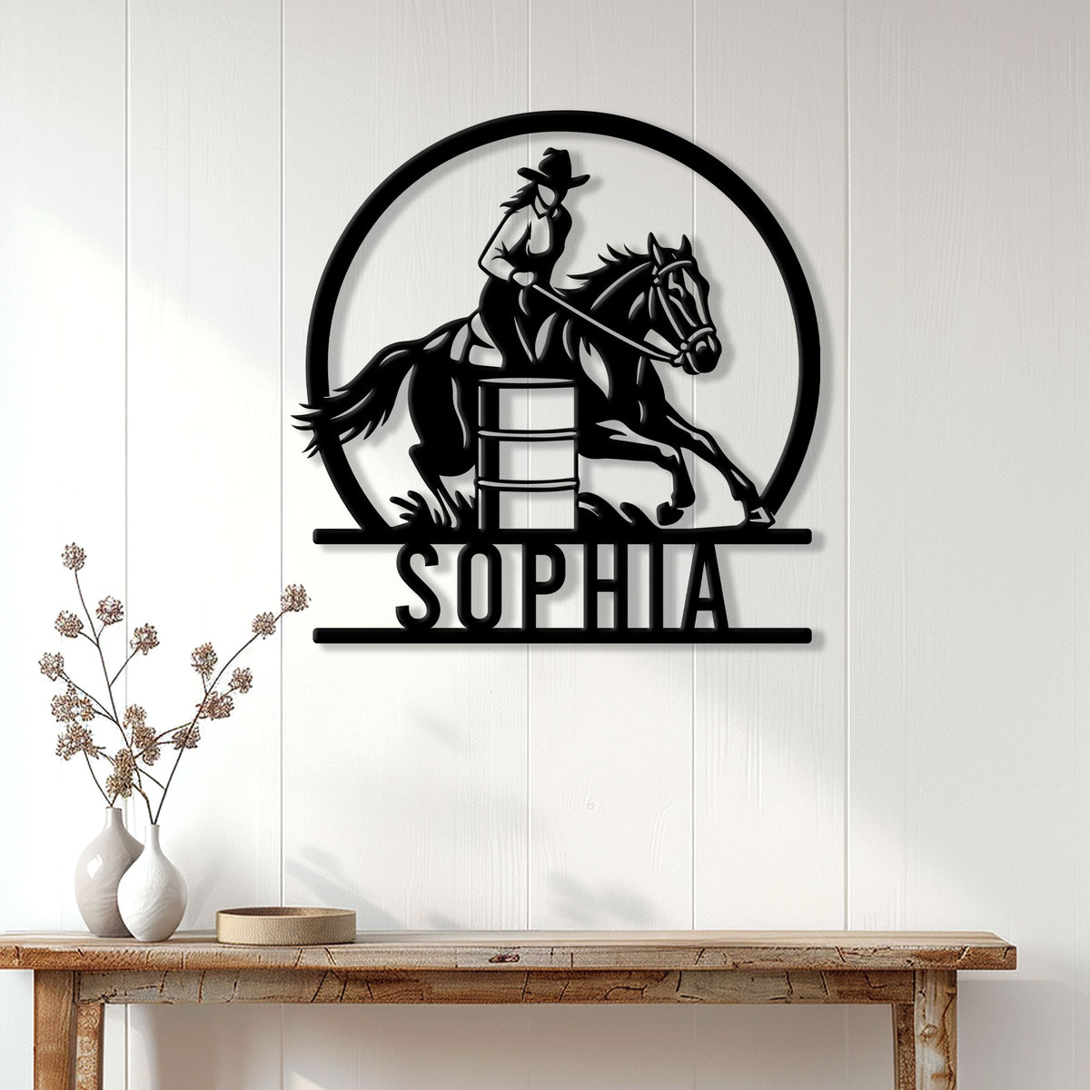 Barrel racing metal wall sign displayed on a bright paneled wall above a rustic console table