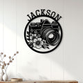 Floral camera wall sign displayed as photography decor on a bright paneled interior wall
