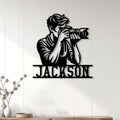 Photographer metal wall sign displayed on white paneling above a console for studio-inspired home decor