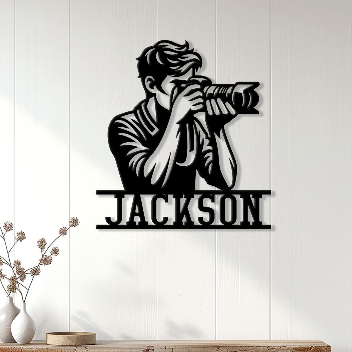 Photographer metal wall sign displayed on white paneling above a console for studio-inspired home decor