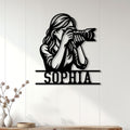 Custom photographer metal sign displayed on a bright paneled wall in a modern home