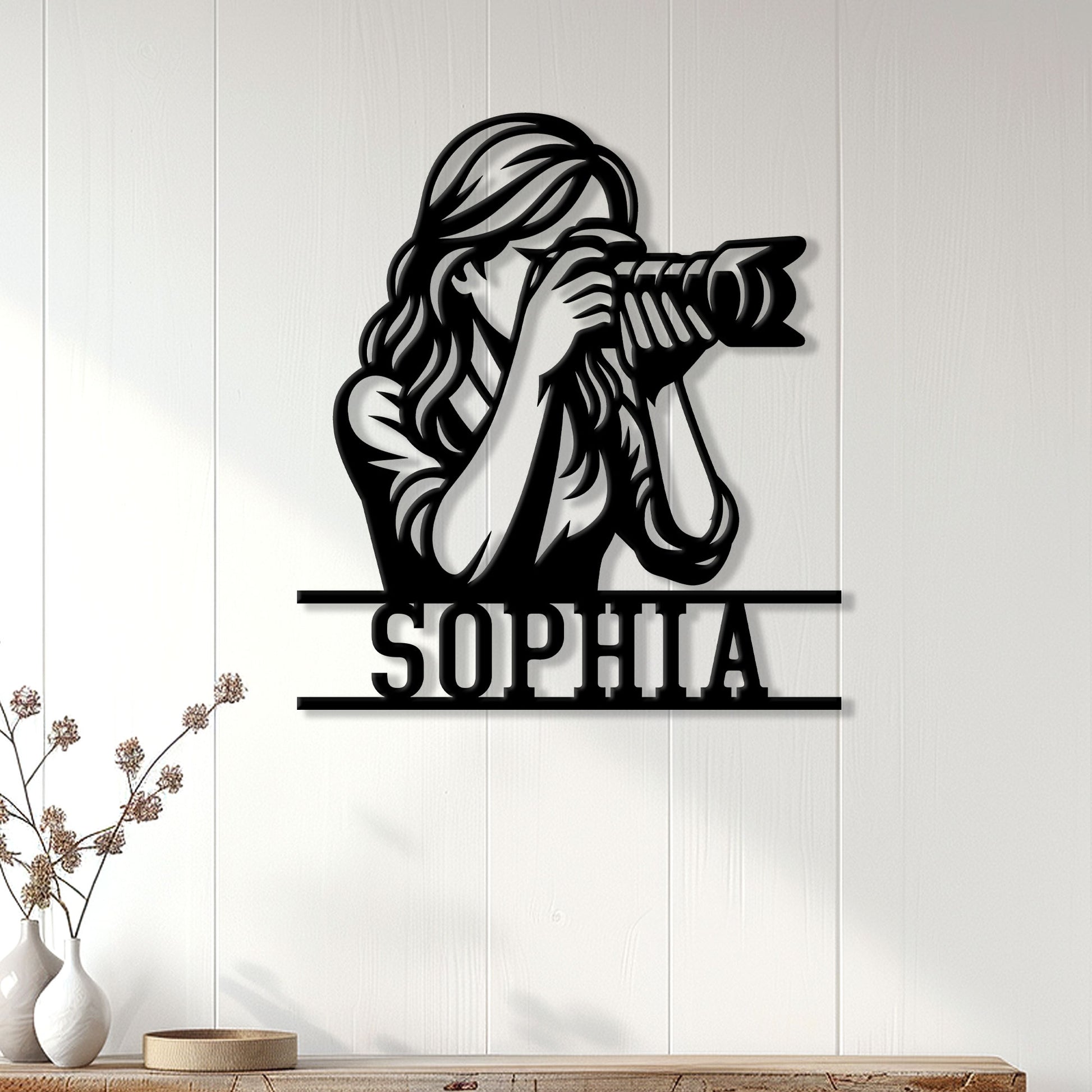 Custom photographer metal sign displayed on a bright paneled wall in a modern home