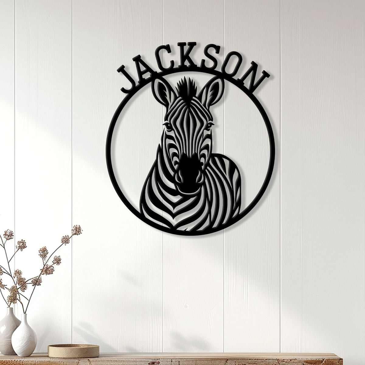 Zebra wall decor displayed on white paneled walls above a console in a bright home