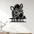 Black zebra metal wall sign displayed on a light paneled wall in a bright home interior