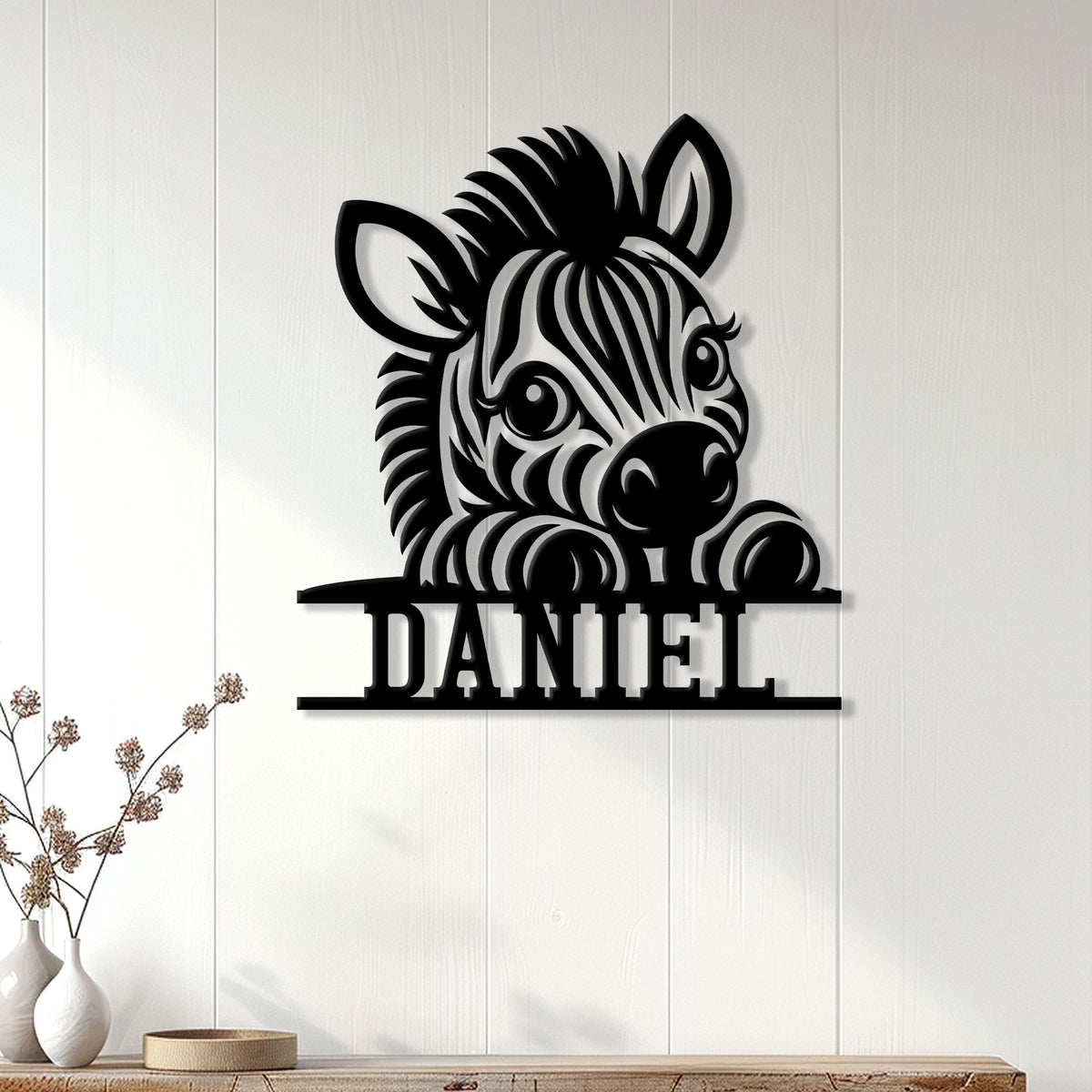 Black zebra metal wall sign displayed on a light paneled wall in a bright home interior